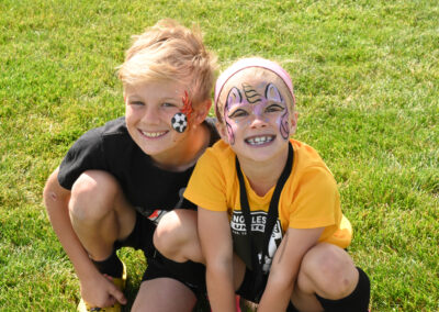 Smiling Children on Soccer Field